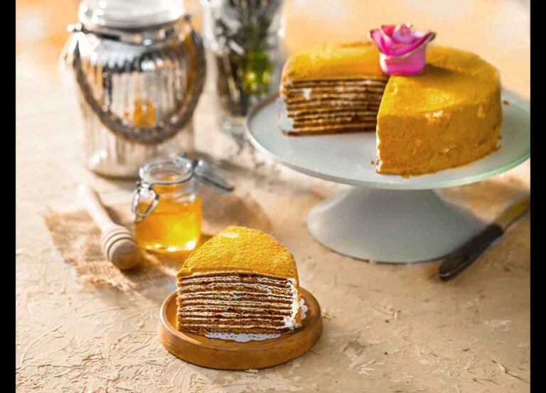 Layered honey cake slice with cream filling
